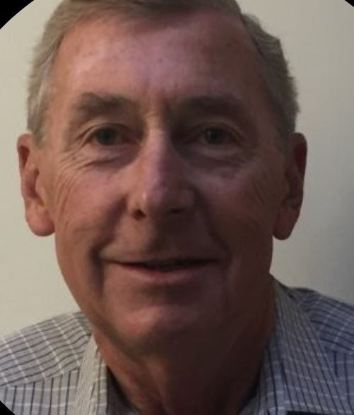 Person wearing a blue and white checked shirt against a plain background.